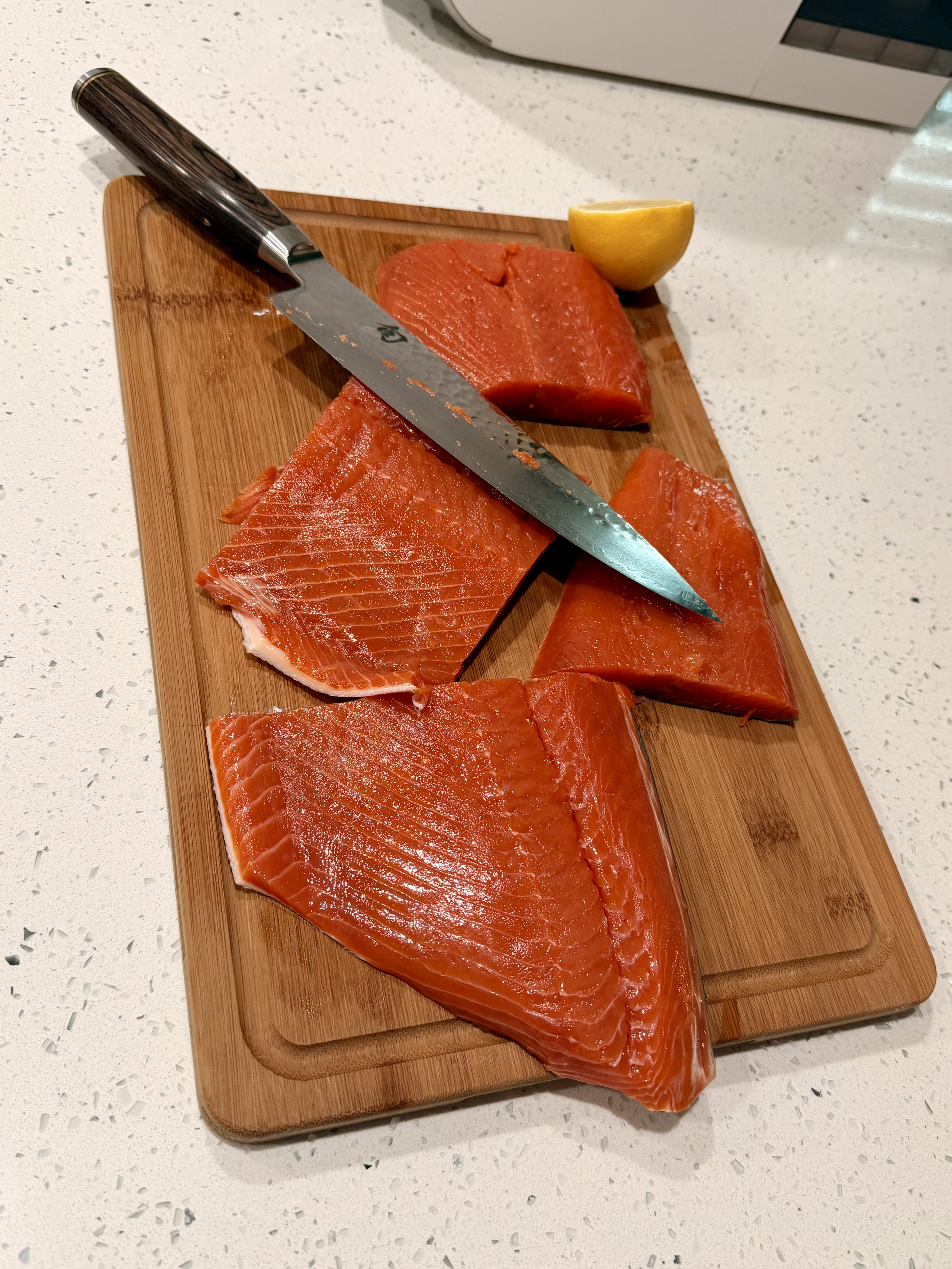 Raw wild-caught salmon portions on a cutting board